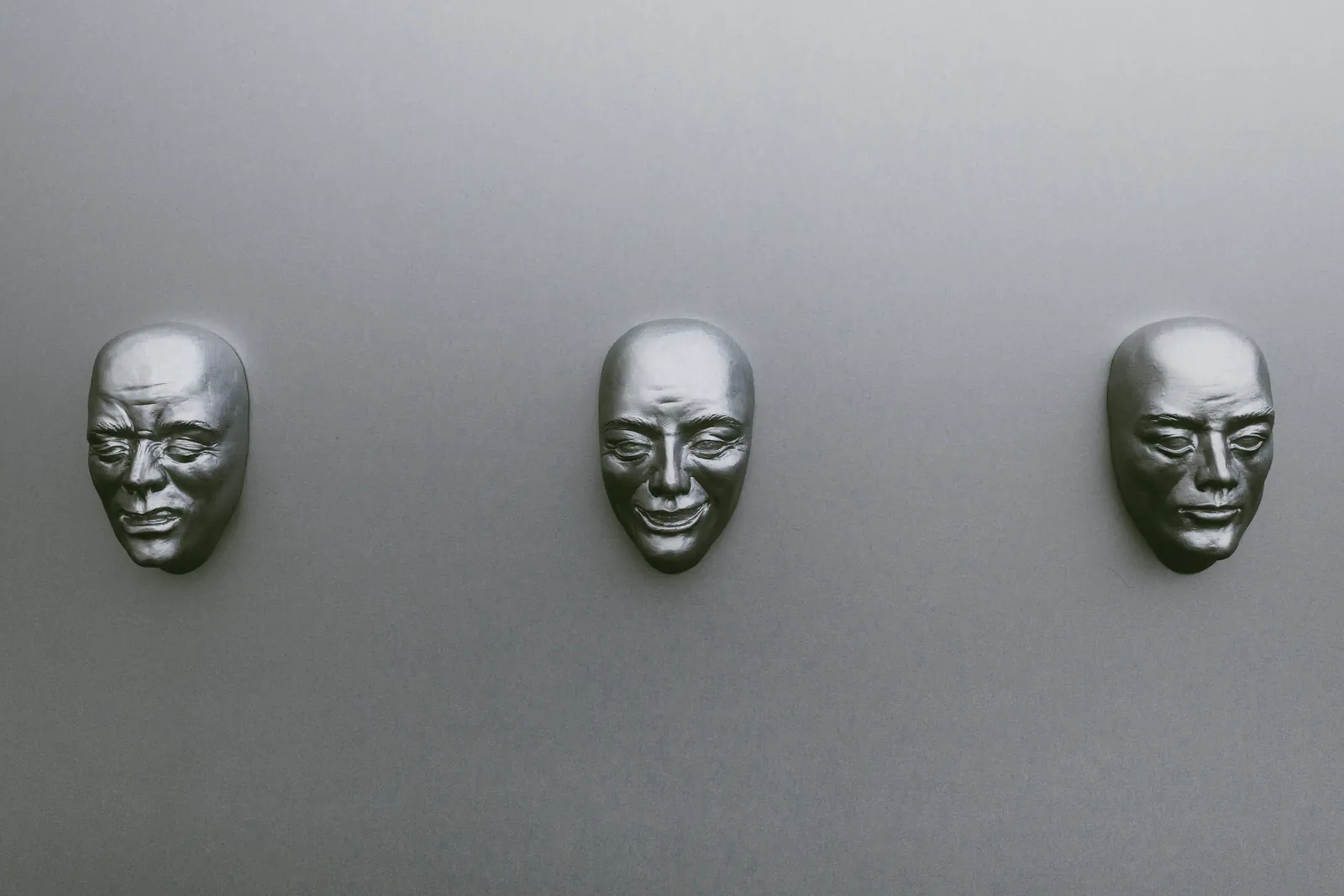 Three silver colored masks